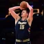 Basketball — Jokic's triple-double draws Denver into contention